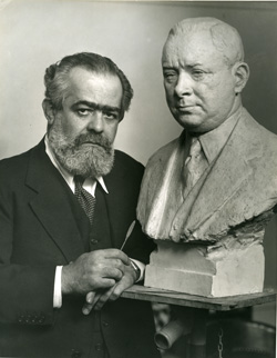 Sculptor Jo Davidson poses with his bust of Sarnoff