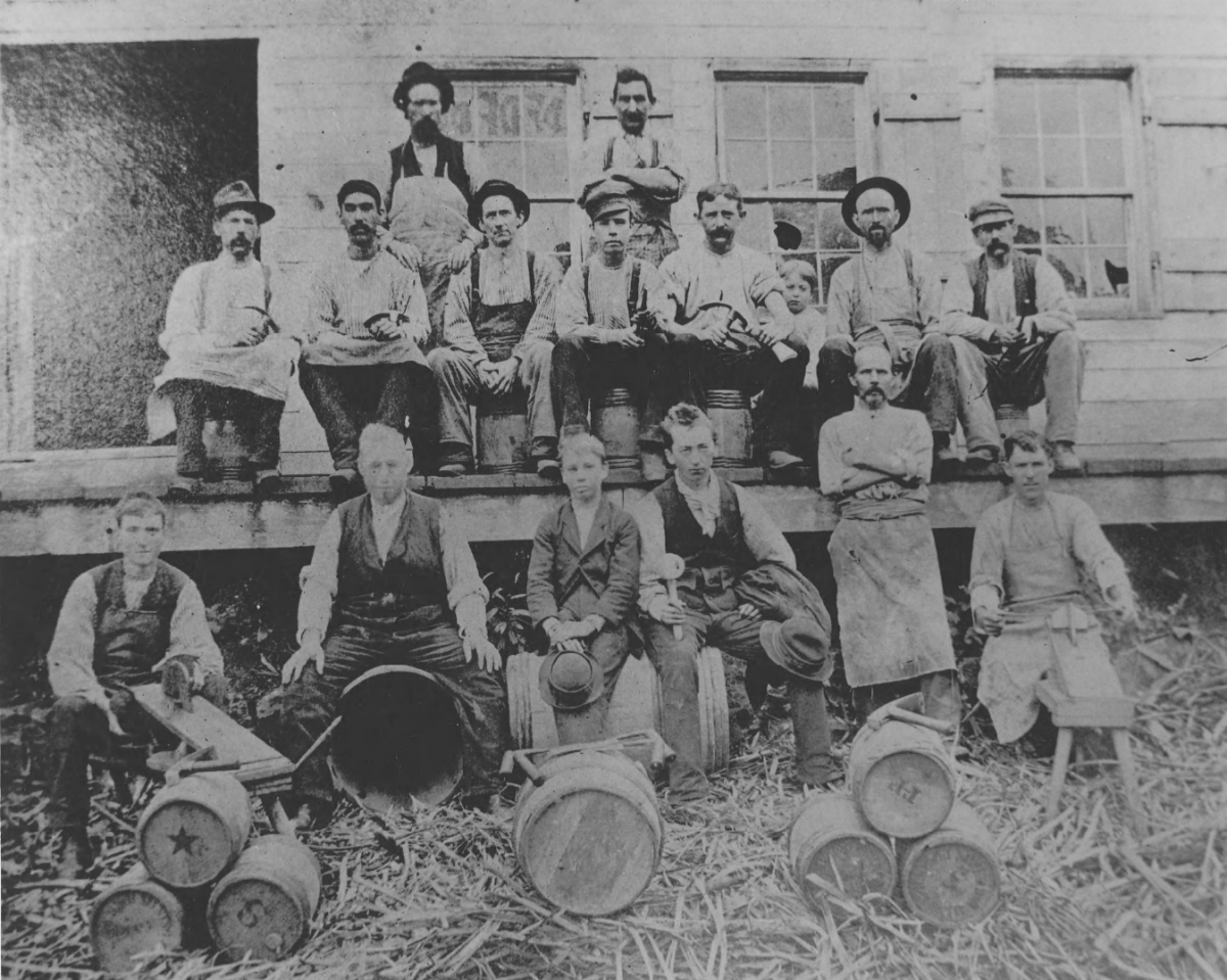 Employees of E.I. du Pont de Nemours & Co.'s wooden keg mill pose with barrels in 1880