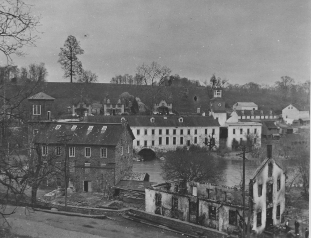 A view of the Brandywine and the mill and buildings that surrounded it. One building is burnt by a fire with no roof.