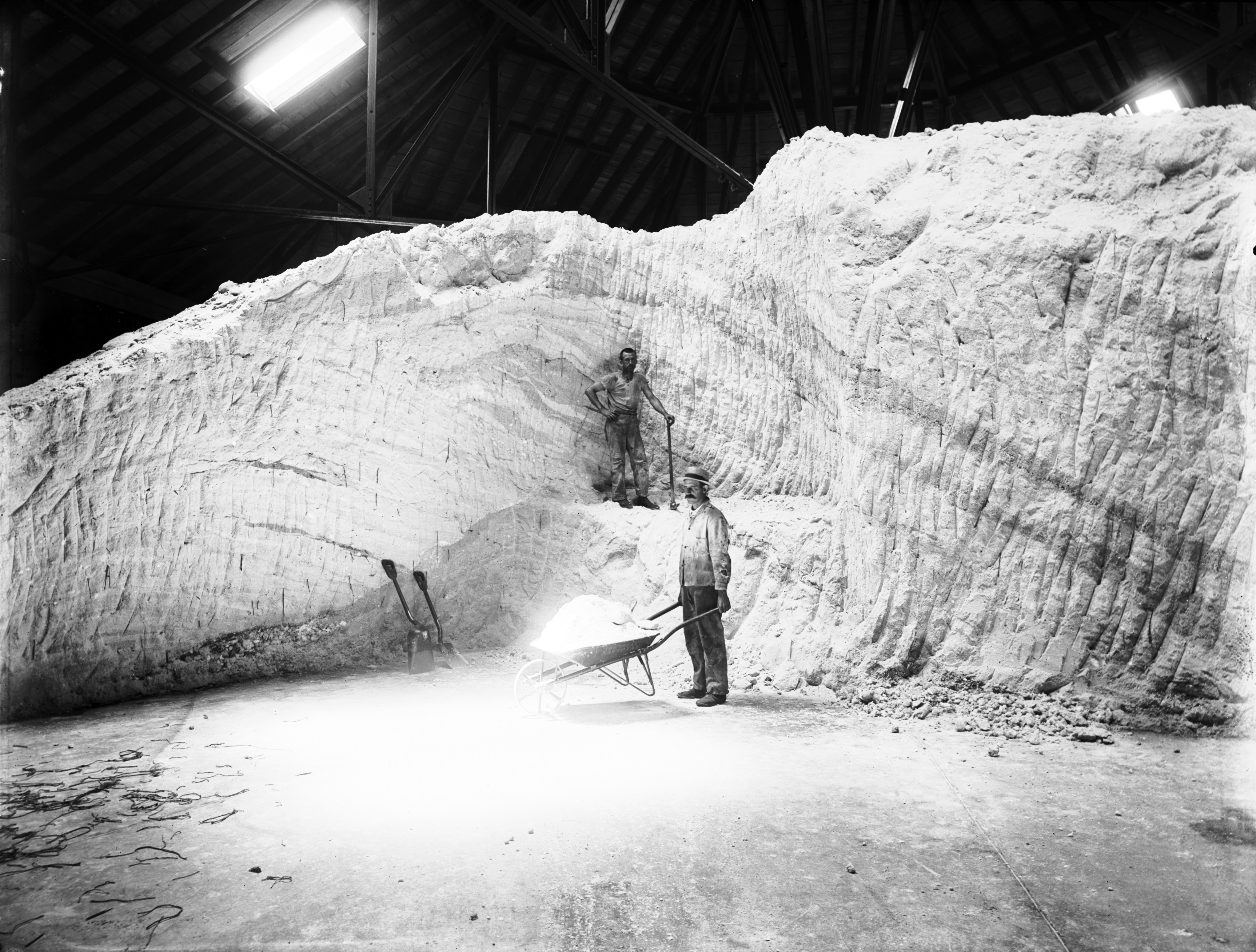 Black and white image of two workers in a soda house.