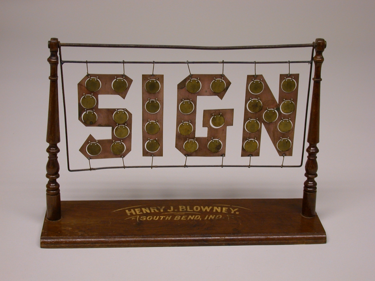A sign that reads "sign" in carved letters.
