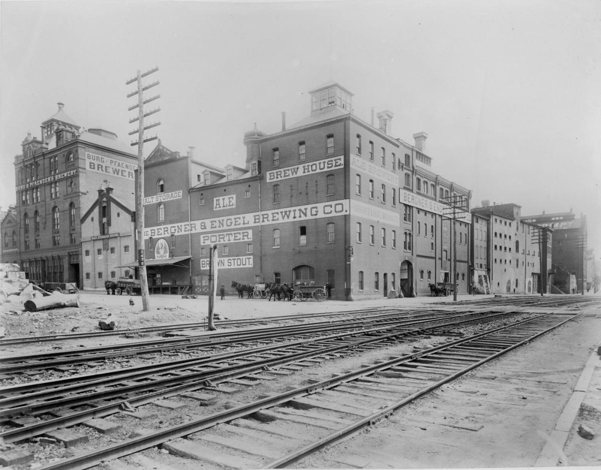 Brewery yard where horse drawn wagons stand outside