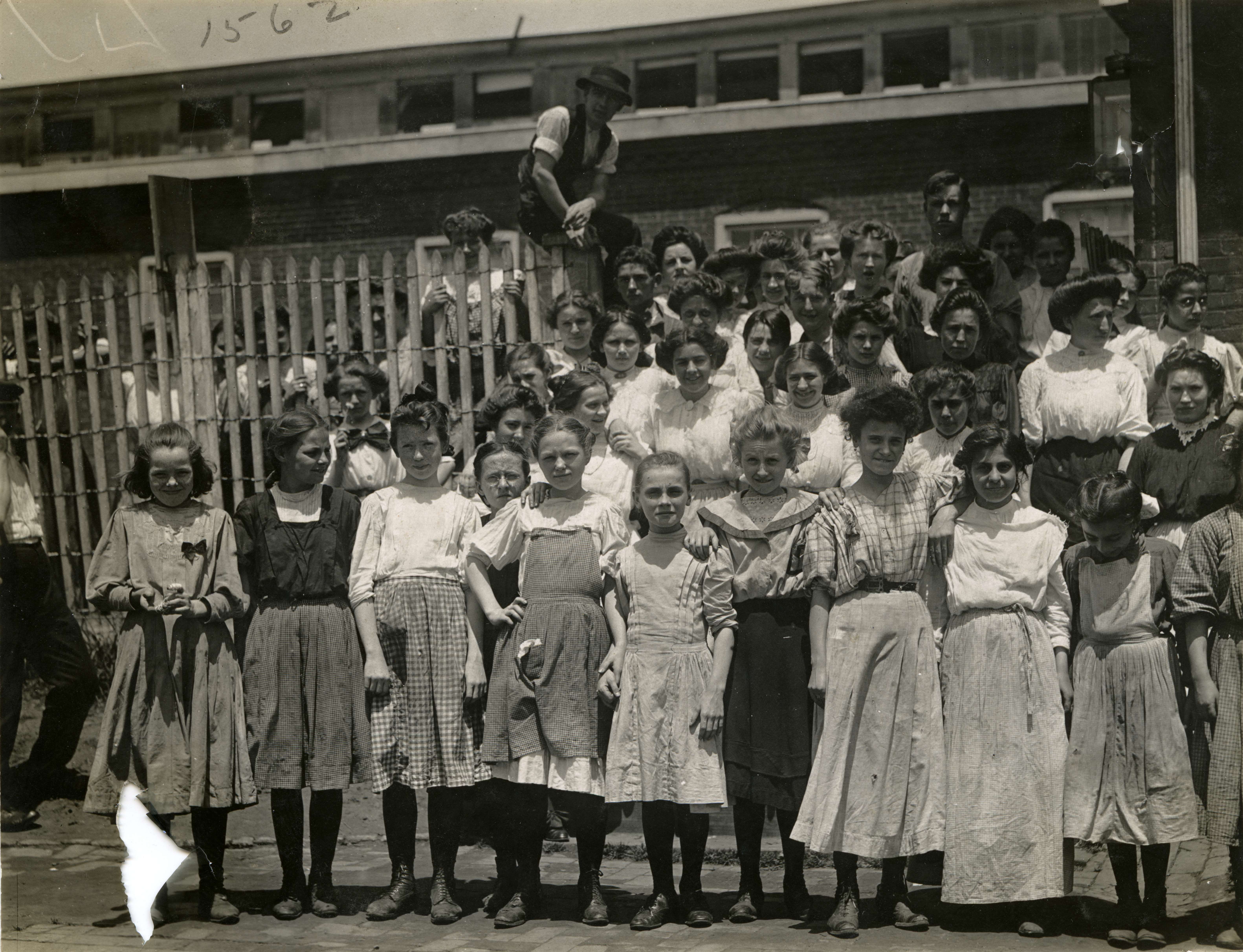 Black and white group photograph of a large number of people, mostly women and young girls.