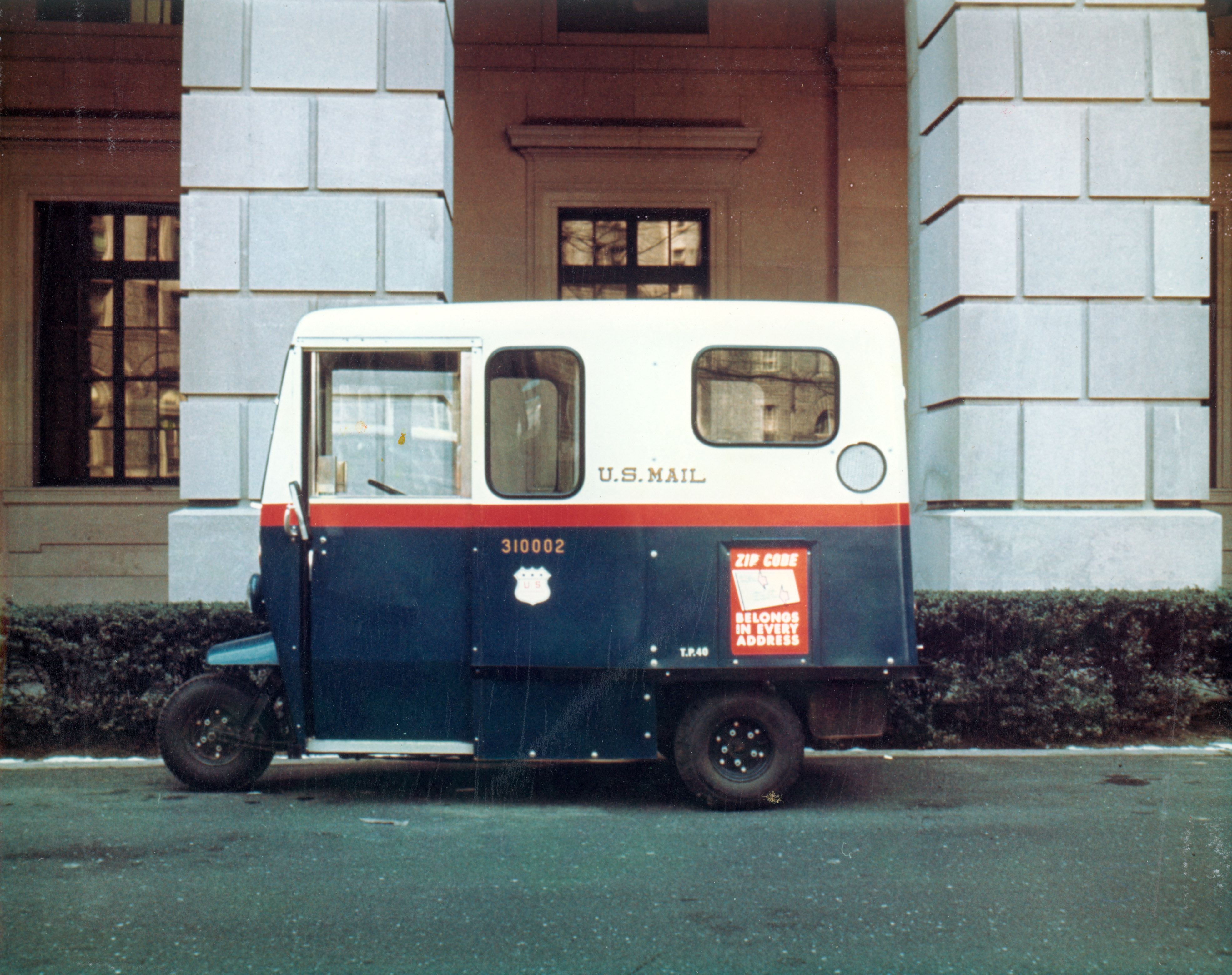 Undated color photograph of a three-wheeled U.S. Mail delivery vehicle.