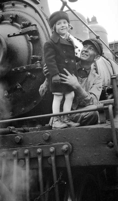 Schoonover’s young son, Cortlandt, getting to climb on a locomotive with the engineer