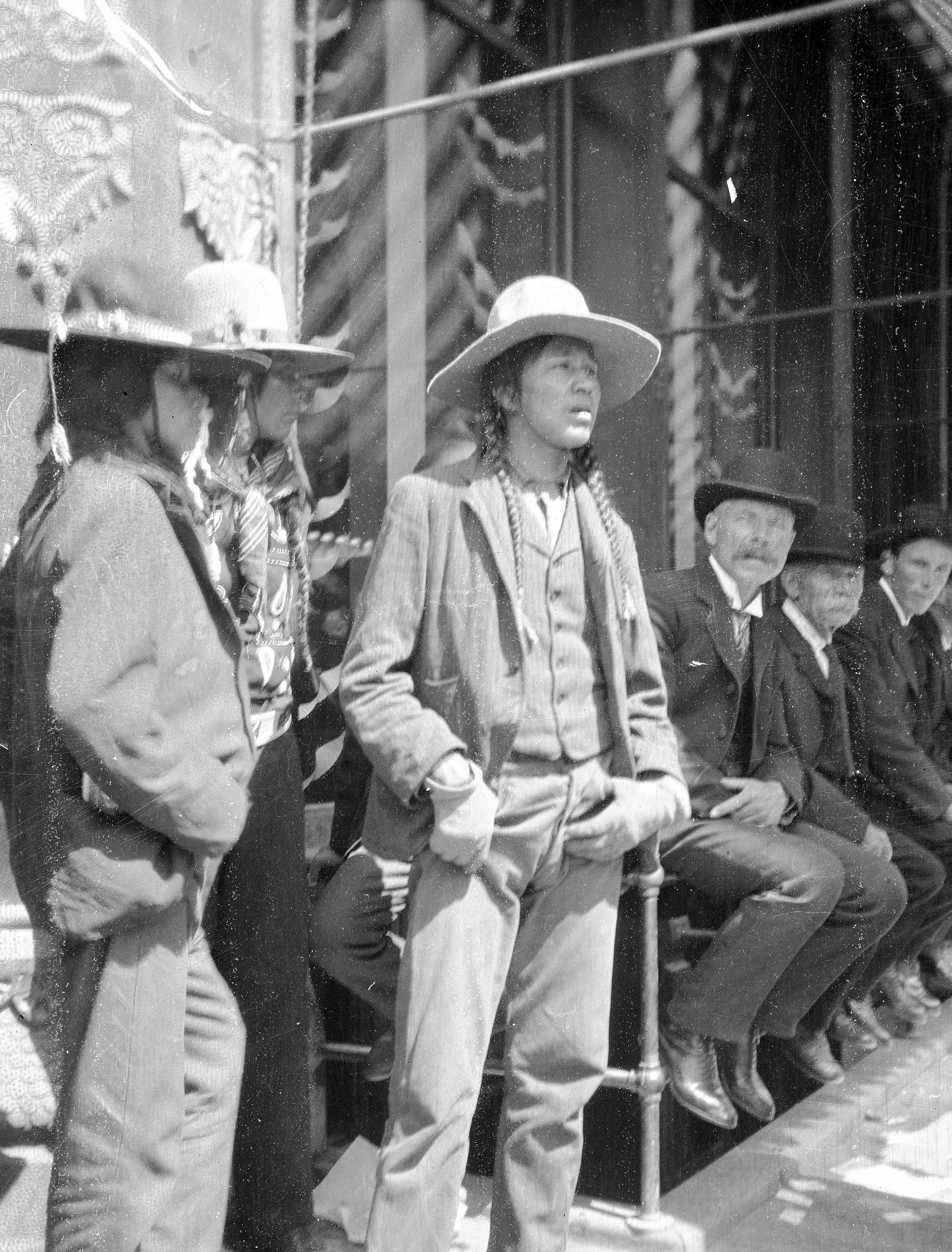 Black and white image of three people from an unidentified Native American population.