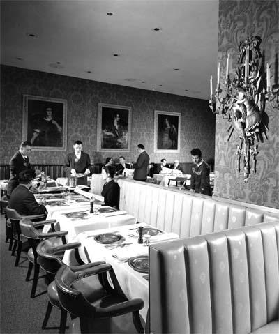Customers and uniformed staff in The Forum of the Twelve Caesars' dining room with three of Camillo Procaccini’s Imperial Caesars paintings in the background, 1957