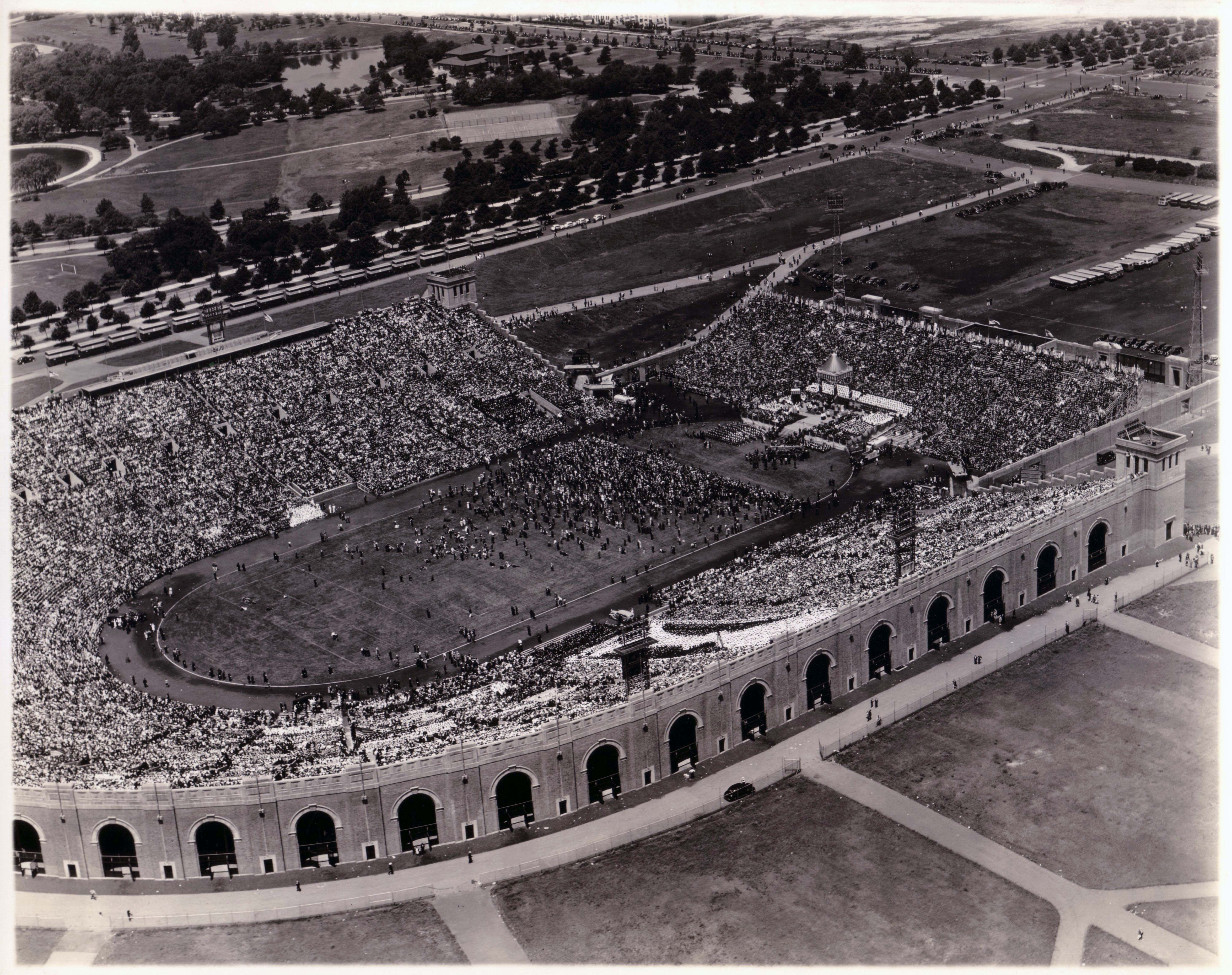 Black and white aerial photograph of an open-air stadium full of people