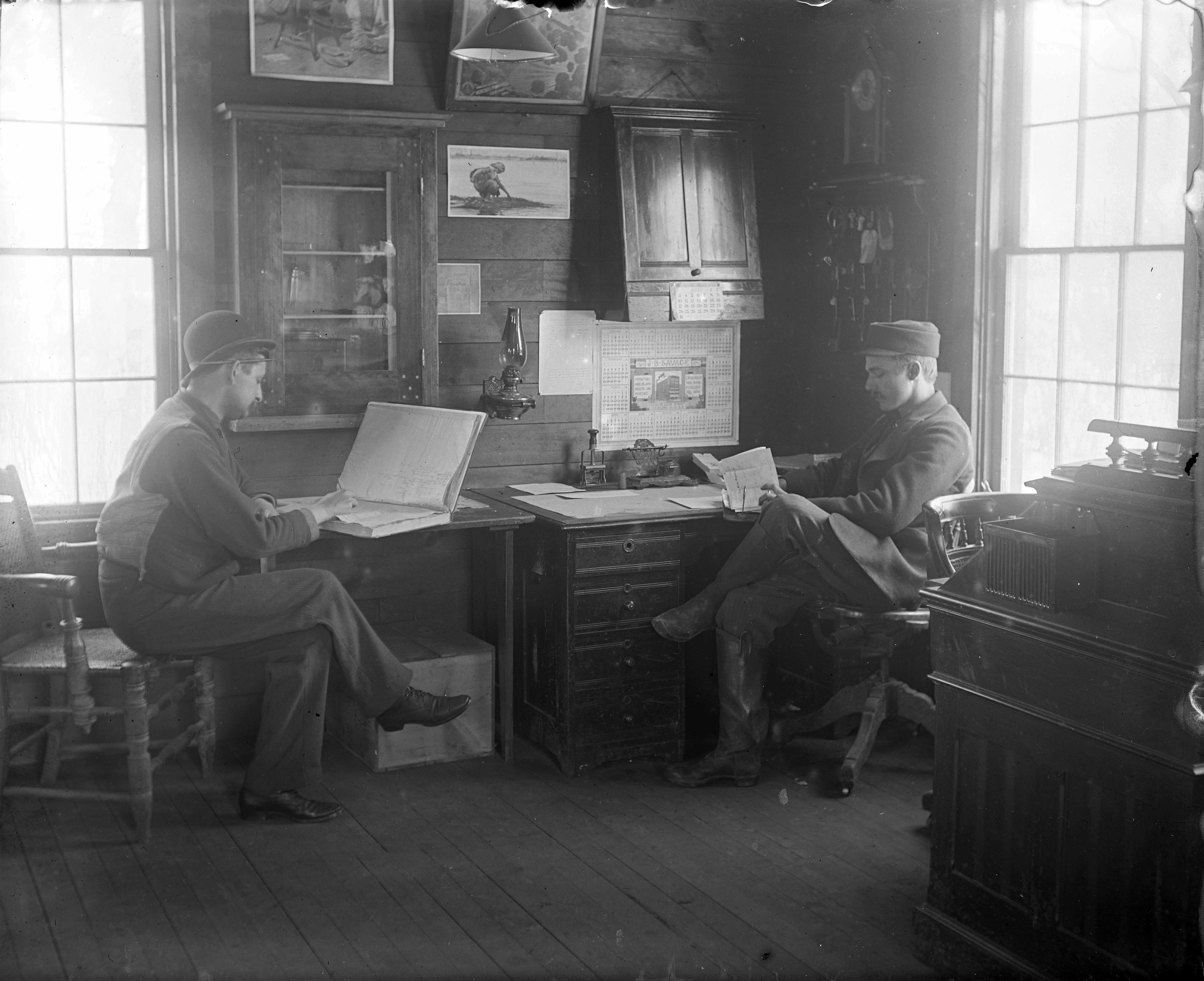 Two men at work in an office, circa. 1895.