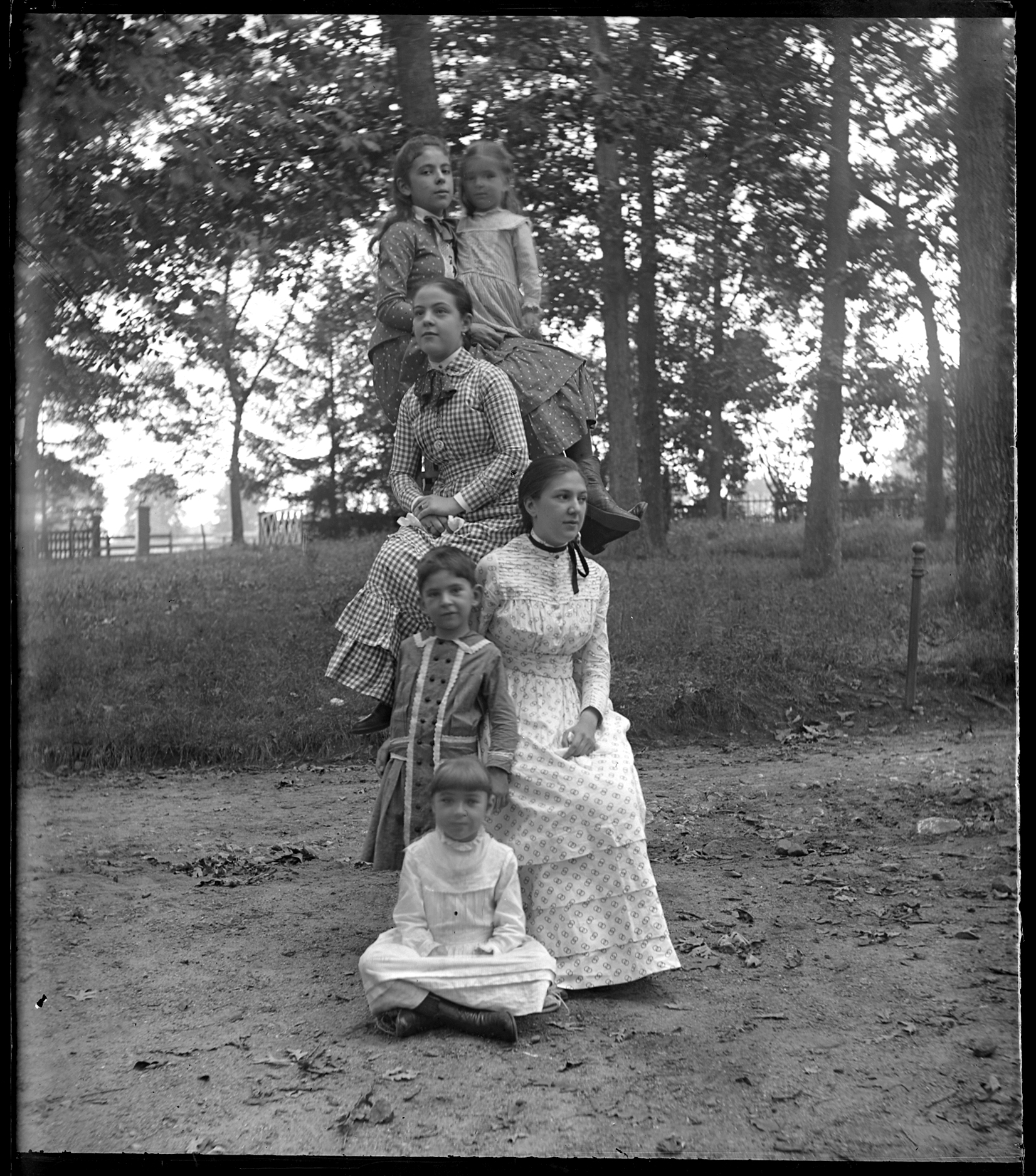 Glass negative showing six children arranged into a tower formation.