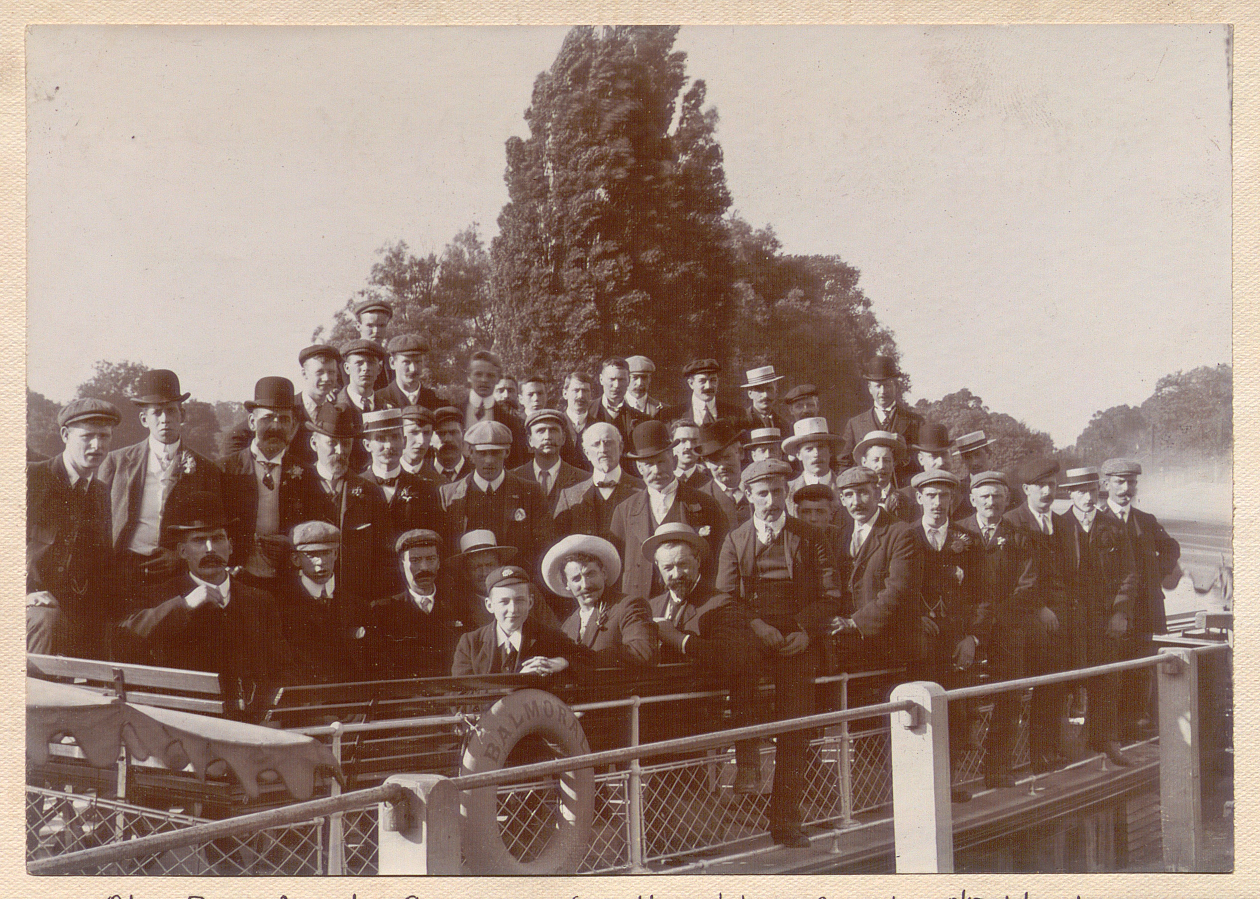 Black and white group photograph of a large number of men, taken outdoors.