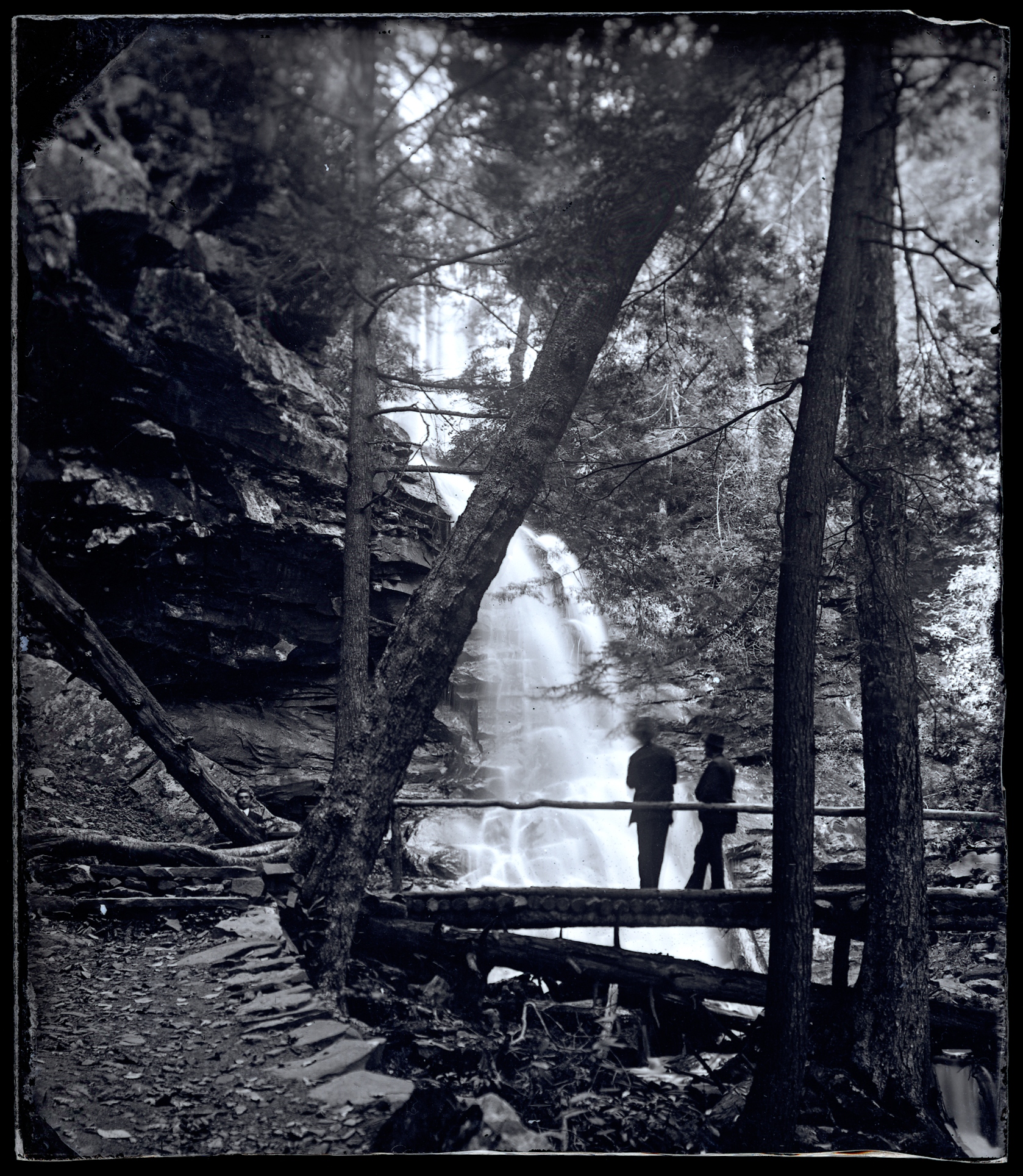 View of two people on a bridge over an unidentified waterfall, probably at Glen Onoko, possibly the cascade above Sunrise Point.