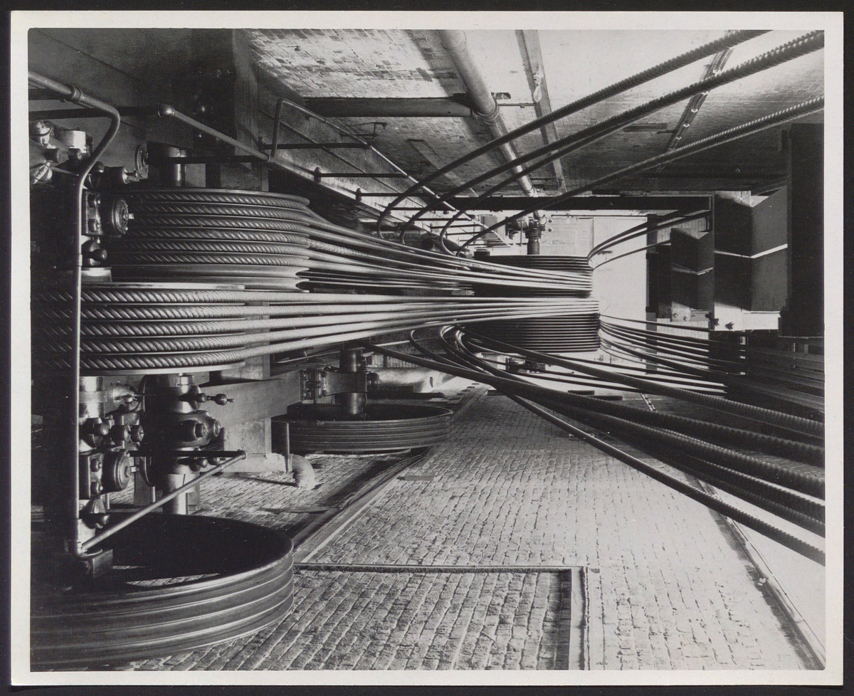 Black and white photo showing a well-composed image of large industrial rolls of cordage.