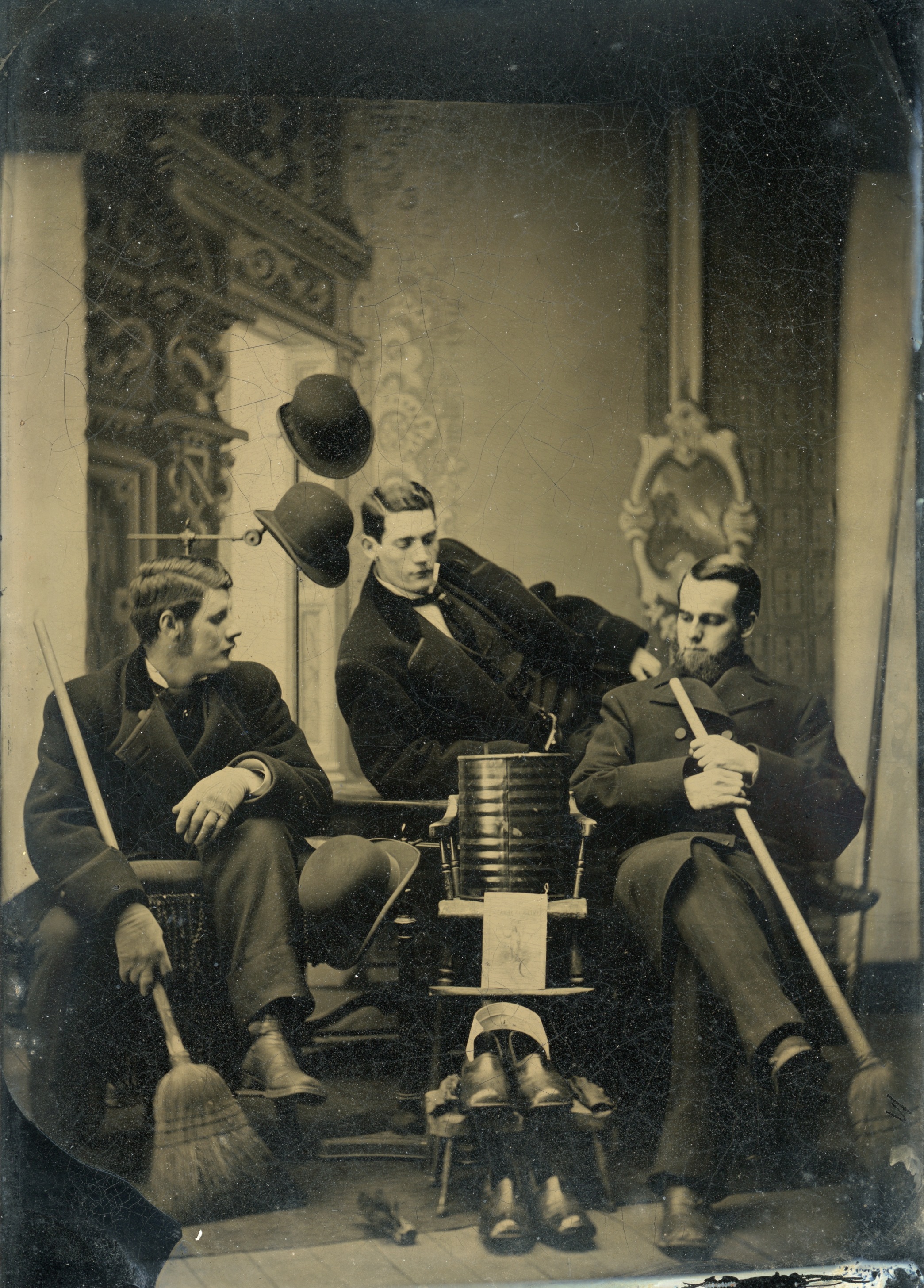 Posed portrait of William and Charles Green, and Albert Studebaker, with powder container
