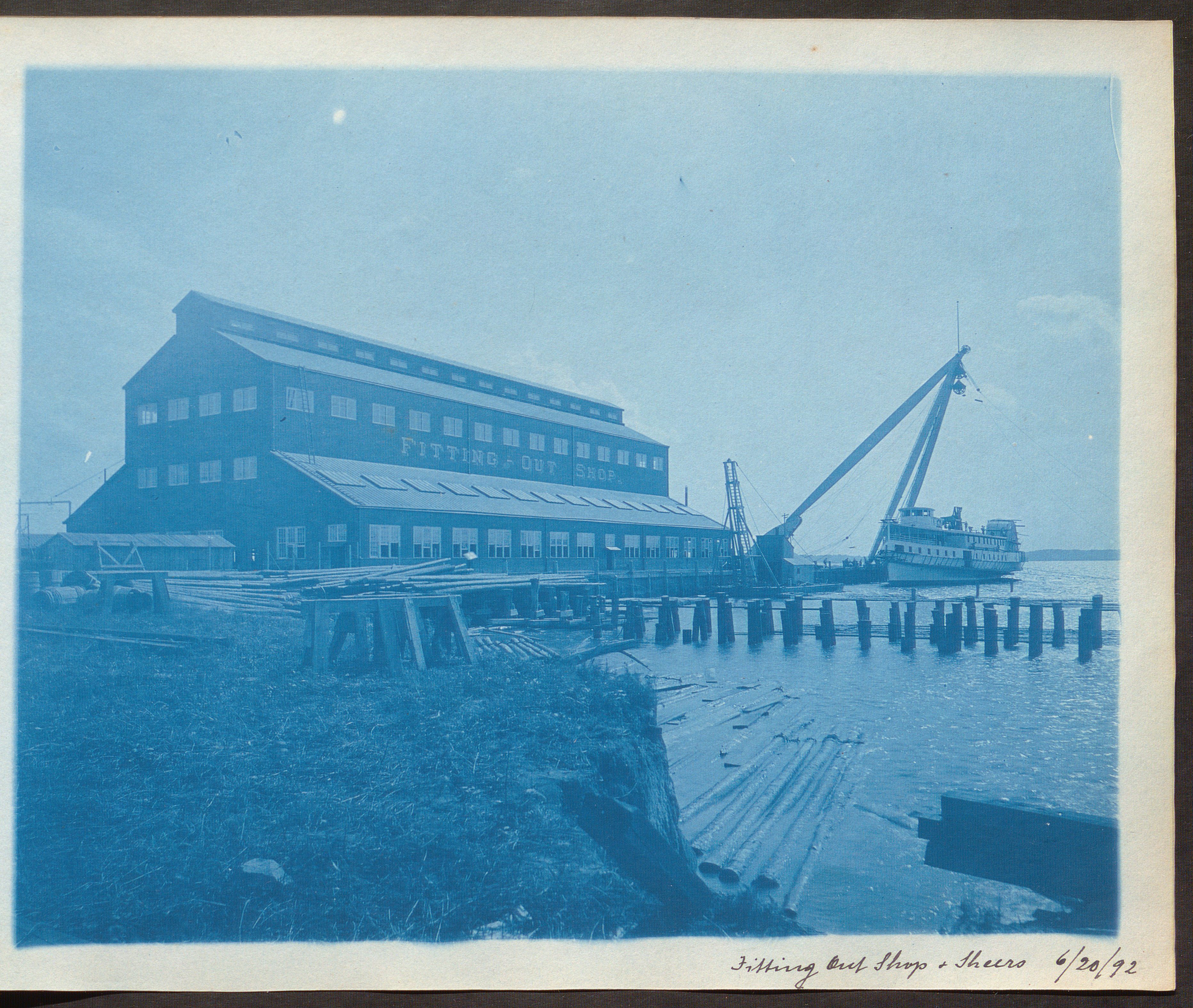 Cyanotype photograph showing a shipyard's fitting out shop and sheers