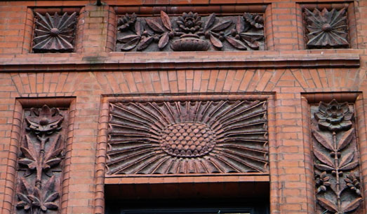 Carved bricks in a floral pattern on a building exterior