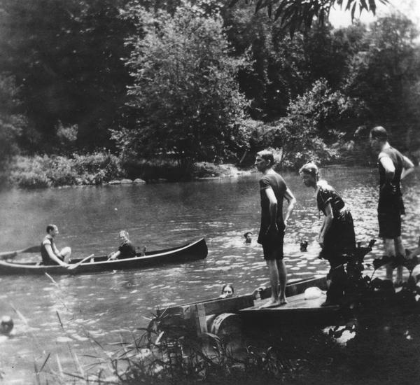 Black and white photograph of people swimming and canoeing in the Brandywine River