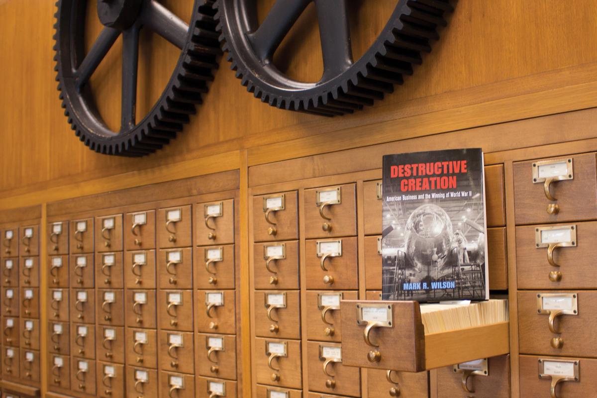 The book "Destructive Creation" in front of library catalog drawers at Hagley Library.