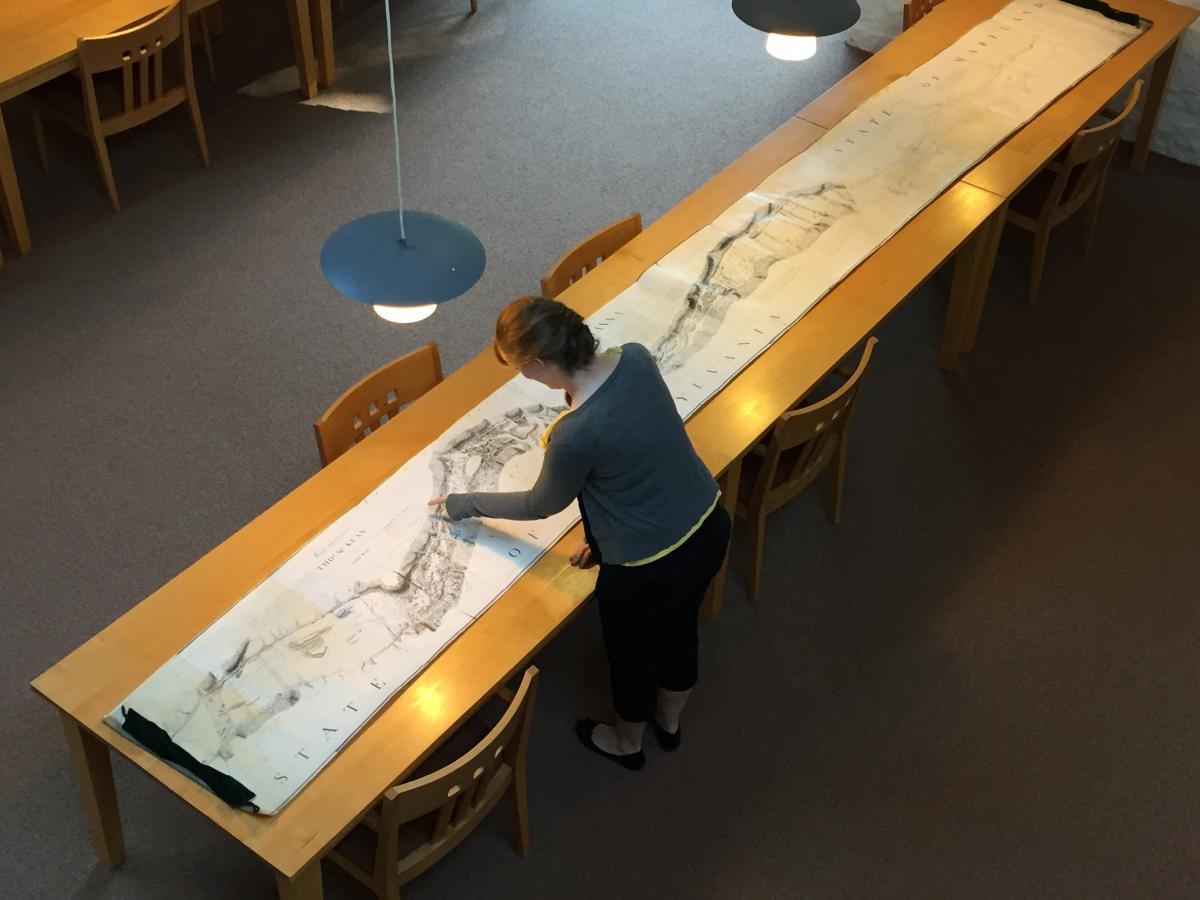 The lengthy map laid out over several long tables.