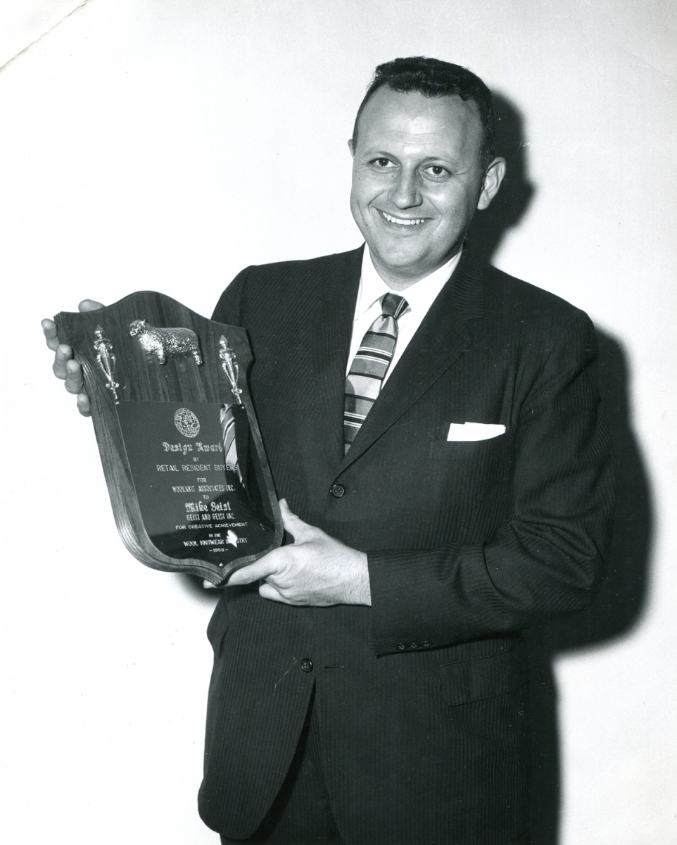 Mike Geist holds a Design Award plaque that he was awarded, 1958