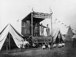 Men on stage at a fair