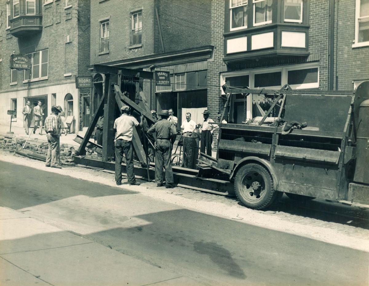 Workers remove streetcar rails