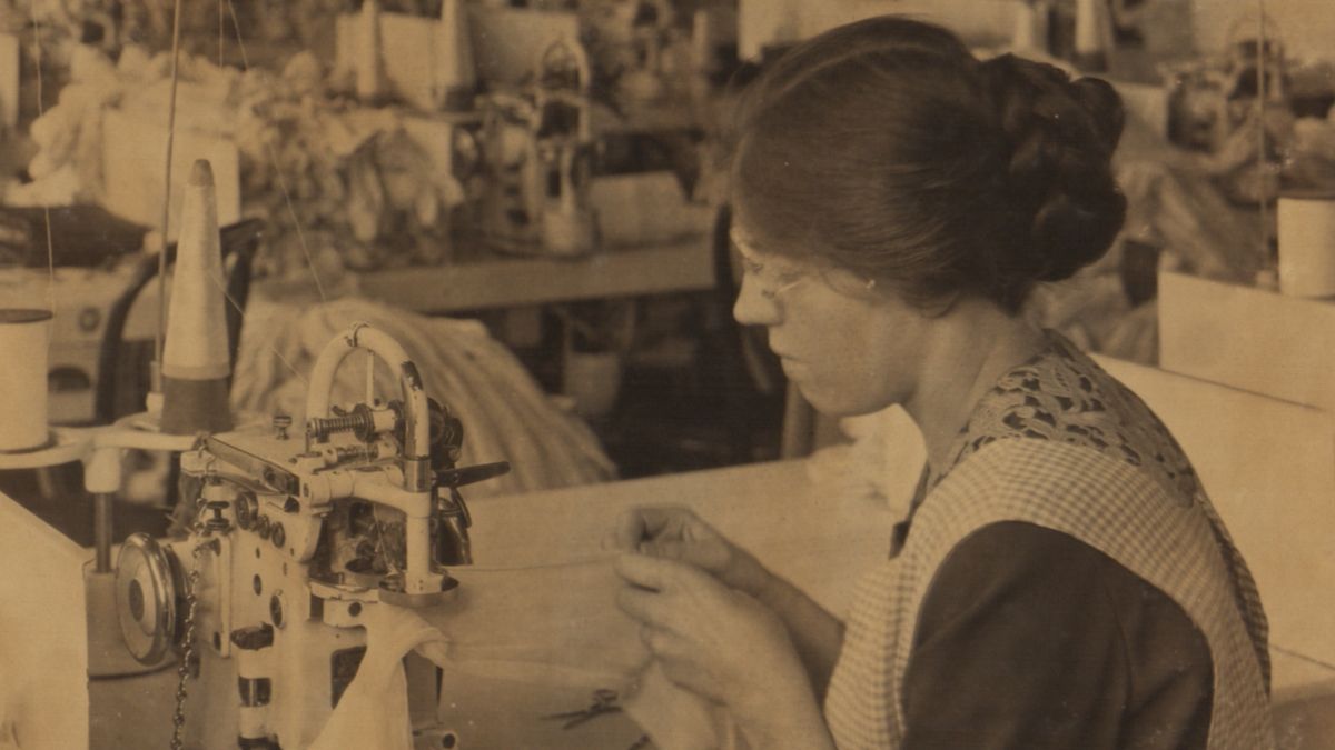 A woman knits in a factory