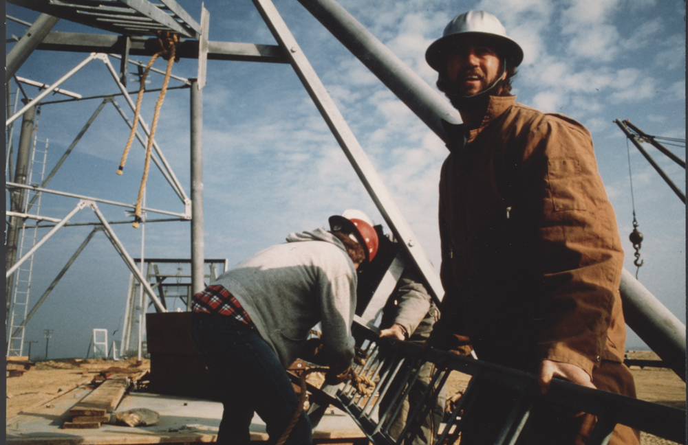 Construction workers build a tower