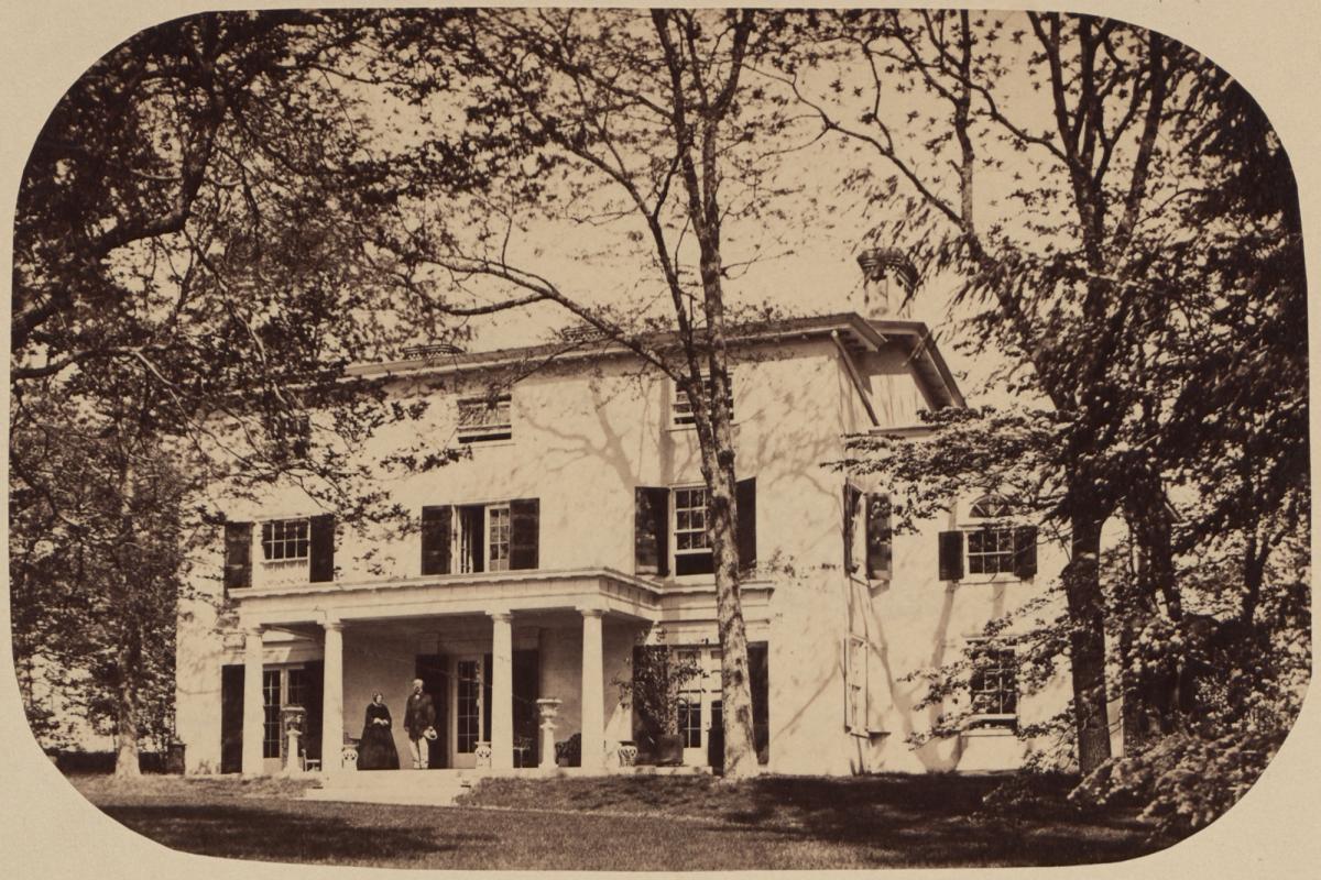 Sophie and Samuel stand outside their home