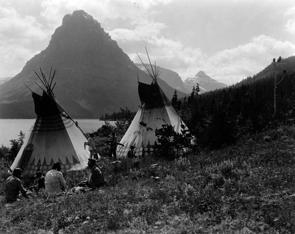 Black and white photograph of Blackfeet on shore of Two Medicine Lake Glacier National Park