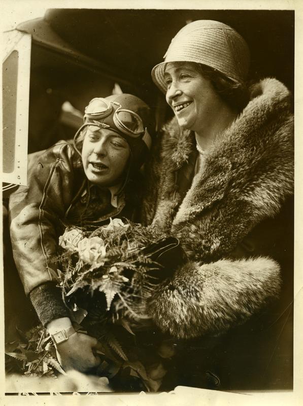 Photograph of a woman pilot hugging an older woman (her mother).