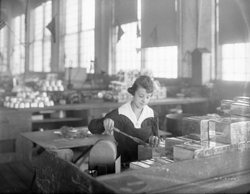 Black and white image from 1919 of a woman at work in the Pennsylvania Railroad's tin shop.