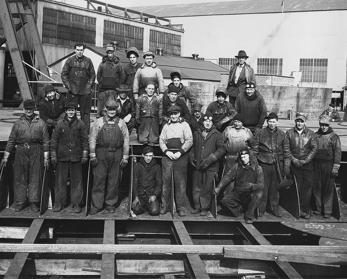 Shipyard employees pose for a group photo