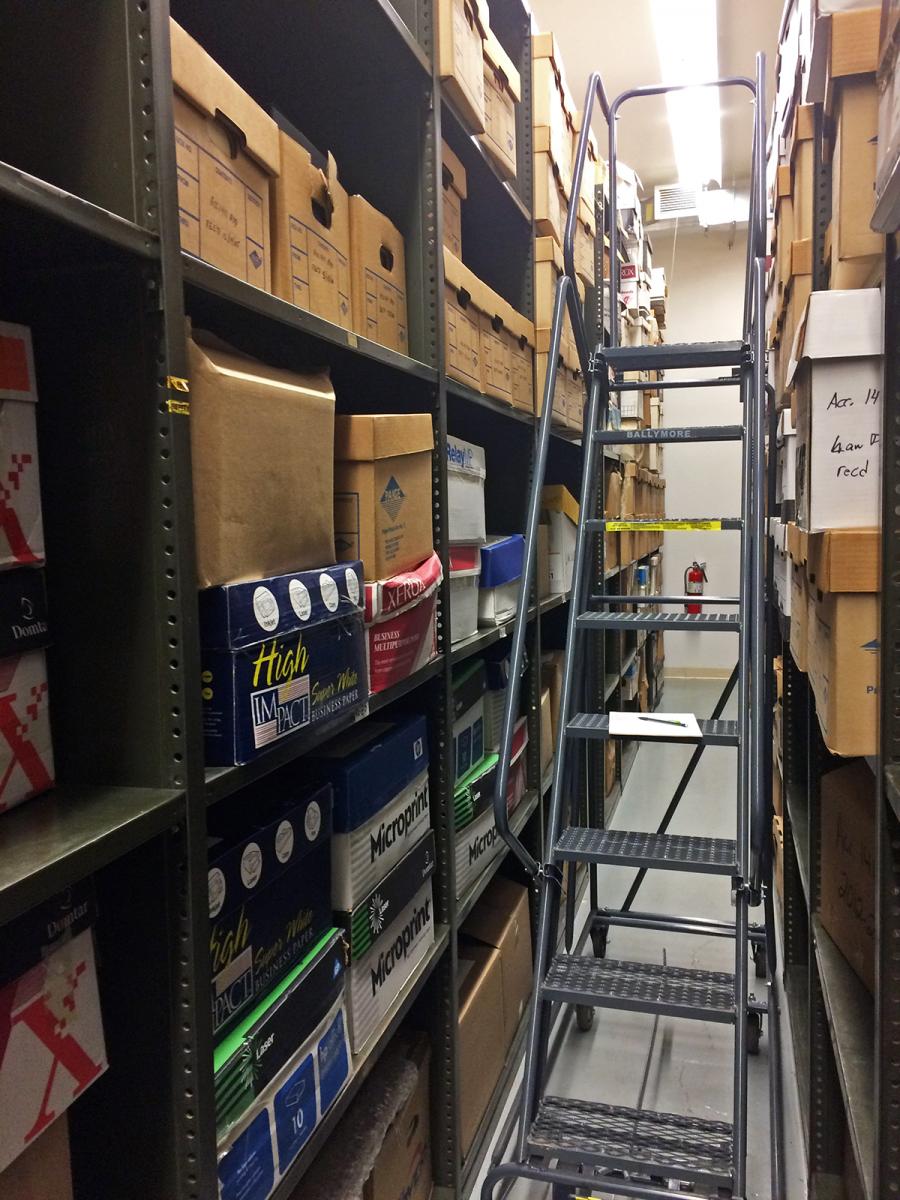 Archives stacks filled with archive boxes and a ladder