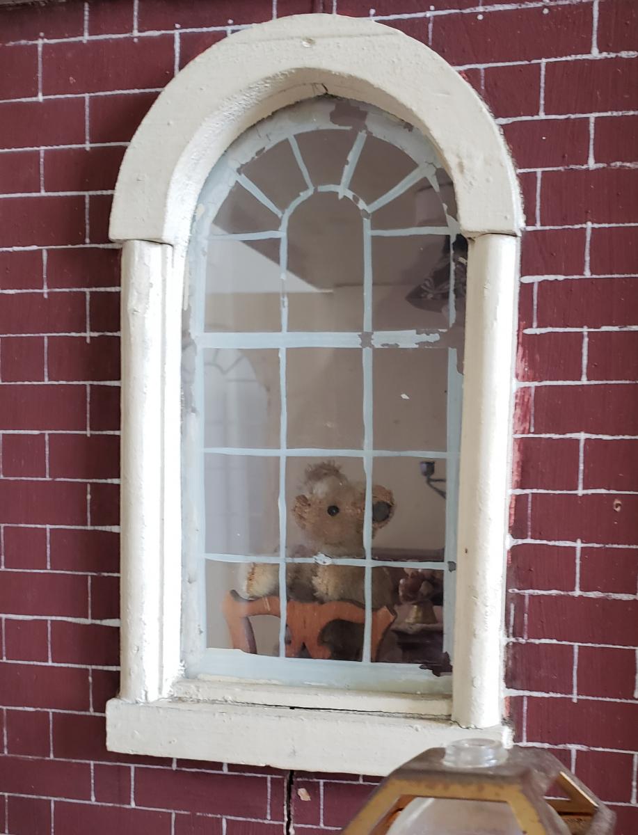 A bear inside the house through the window