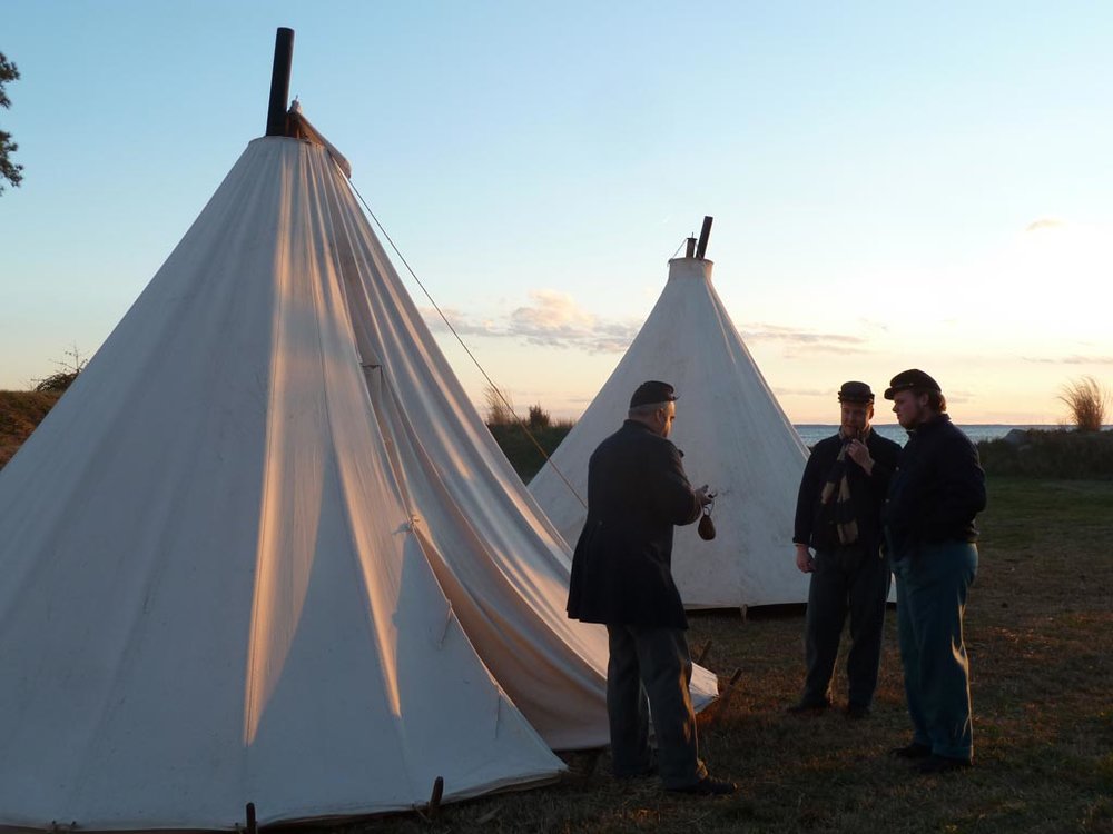 Two Sibley tents set up at a historical reenactment