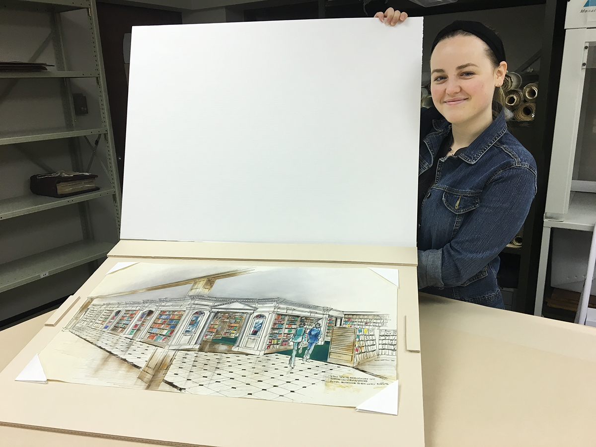 Intern, Erin Cunningham, with the sink mat she created for the watercolor and pastel elevation drawing of the entrance to the Boston University Bookstore, 1983.