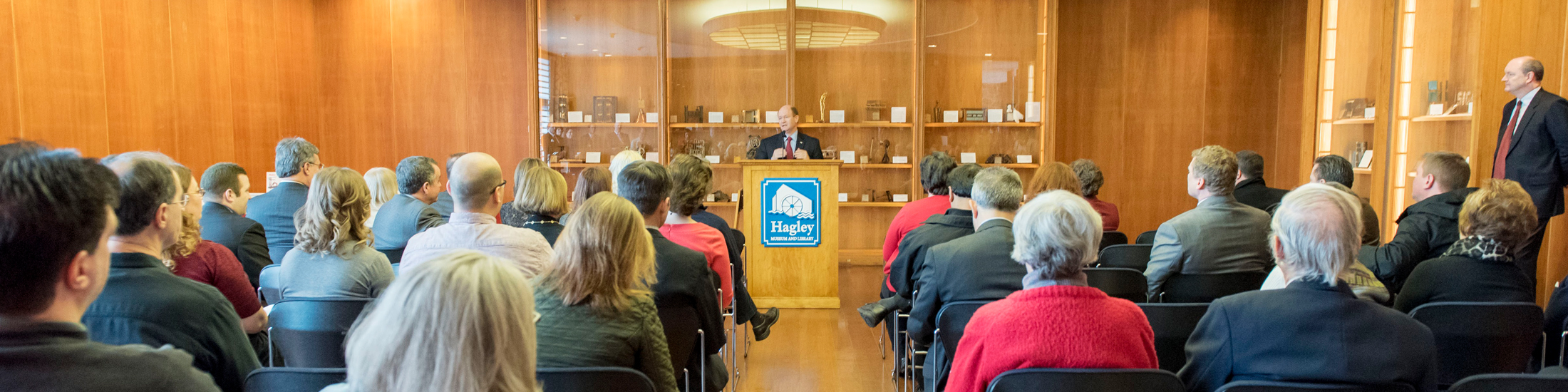 Visitors listen to a speaker at Hagley.