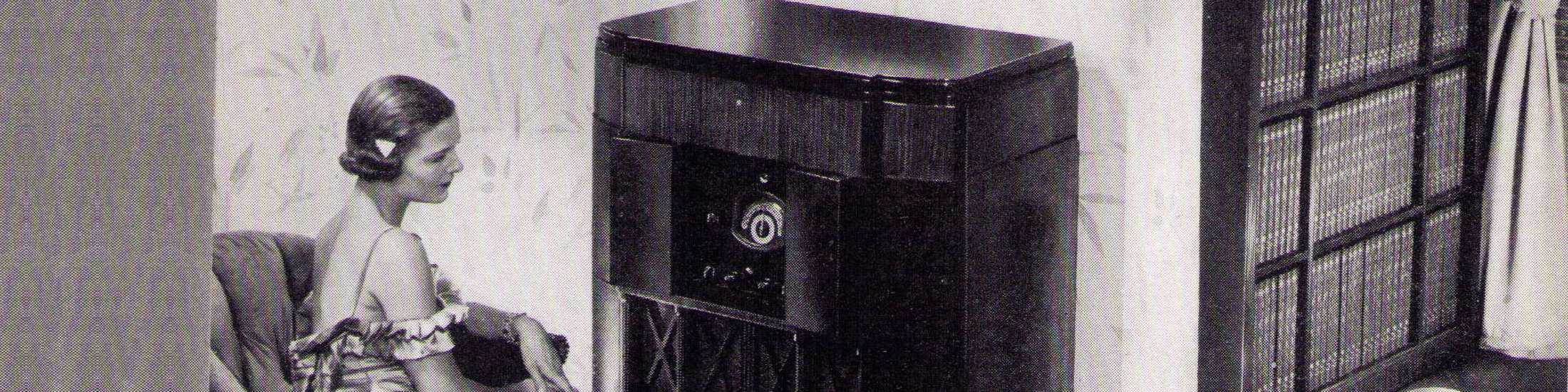 A woman listens to her radio, 1930s