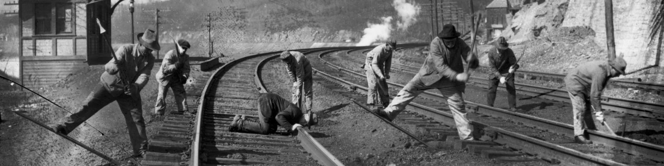 Railroad workers leveling tracks