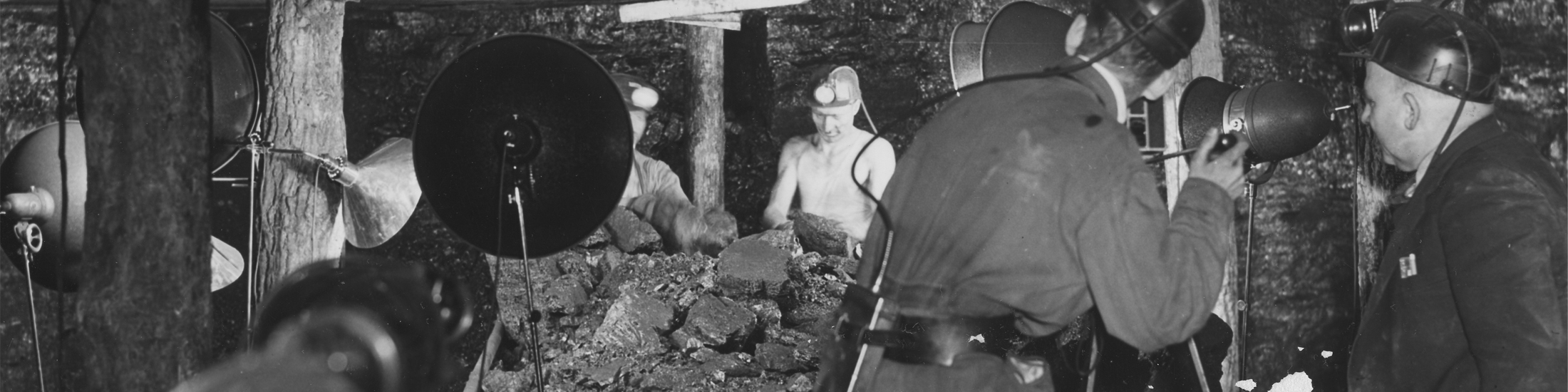 Coal miners in West Virginia are filmed by a tv crew with cameras