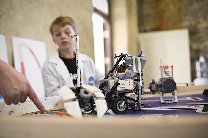 Boy looking at robot