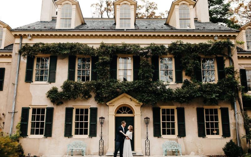 bride and groom in front of eleutherian mills