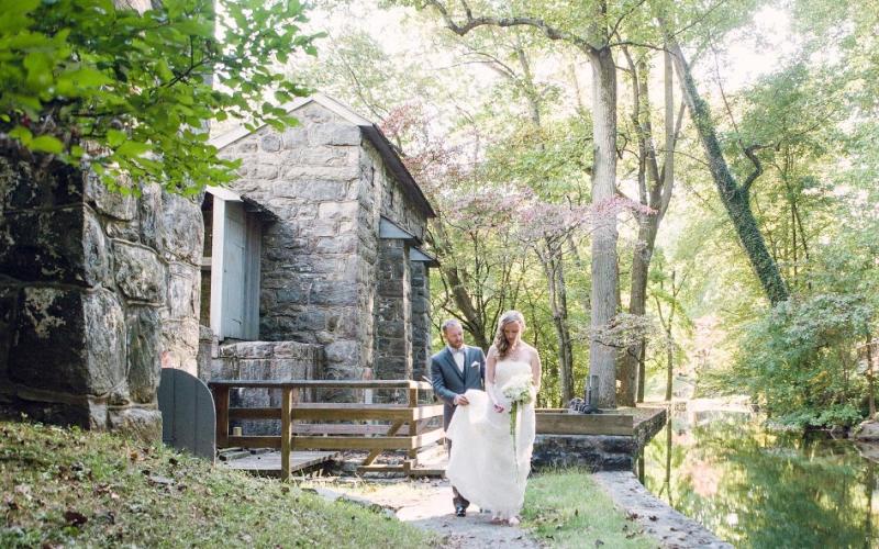 bride and groom by water wheel