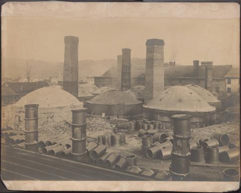 Industrial site with large structures and chimneys.