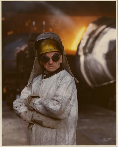 Color photograph of a steelworker in protective clothing