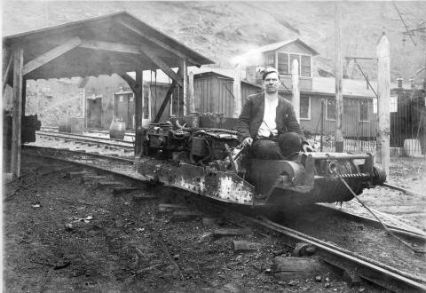Man operating a mine haulage train 