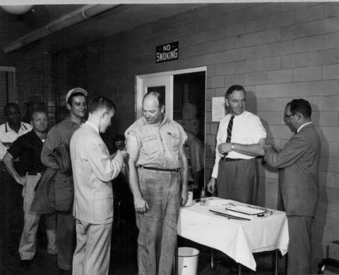 Photograph of Westinghouse employees receiving influenza A (H2N2) shots at the dispensary