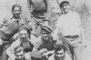 Black and white photograph of eight men forming a human pyramid