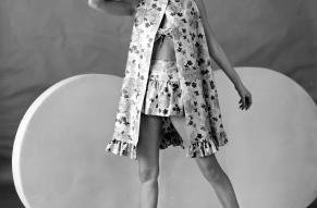 Black and white fashion photo of a woman in a 2-piece bathing suit and cover-up.